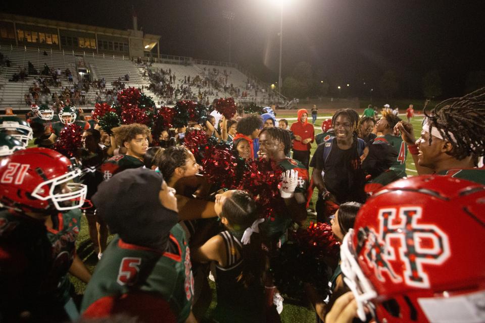 Highland Park senior Tre Richardson (6), middle, celebrated with cheerleaders and teammates after defeating Wyandotte 60-47 Sept. 2 at Hummer Sports Park. The win broke an 8-year-long losing streak.