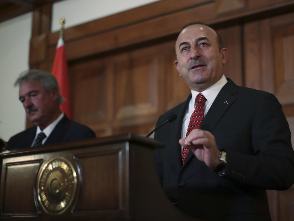 Turkey's Foreign Minister Mevlut Cavusoglu, talks to the media during a joint news conference with Luxembourg's Foreign Minister Jean Asselborn following their meeting in Ankara, Turkey, Monday, Jan. 14, 2019. Cavusoglu responded to U.S. President Donald Trump's threat to devastate Turkey economically if it attacks U.S.-backed Kurdish forces in Syria. Cavusoglu also rebuked Trump for issuing the warning via Twitter saying "strategic partners" do not speak to each other through social media. (Cem Ozdel/Turkish Foreign Ministry via AP, Pool)