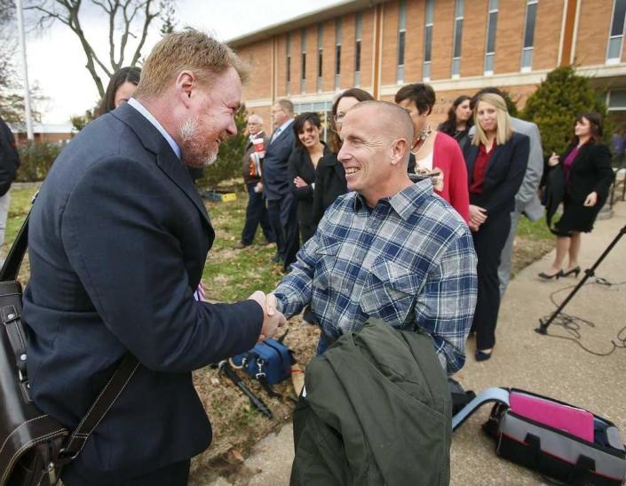 Floyd Bledsoe, right, is greeted by Oliver Burnette, executive director of the Midwest Innocence Project, in 2015 after being cleared of the 1999 murder of his sister-in-law, 14-year-old Camille Arfmann.