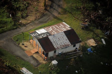 A message written on the rooftop is seen from the air during recovery efforts following Hurricane Maria near Humacao, Puerto Rico, October 10, 2017. REUTERS/Lucas Jackson