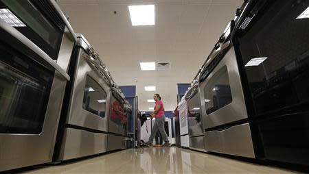 A woman walks by stoves in the appliance section at a Sears store in Schaumburg, Illinois near Chicago in this file photo taken September 23, 2013. REUTERS/Jim Young/Files