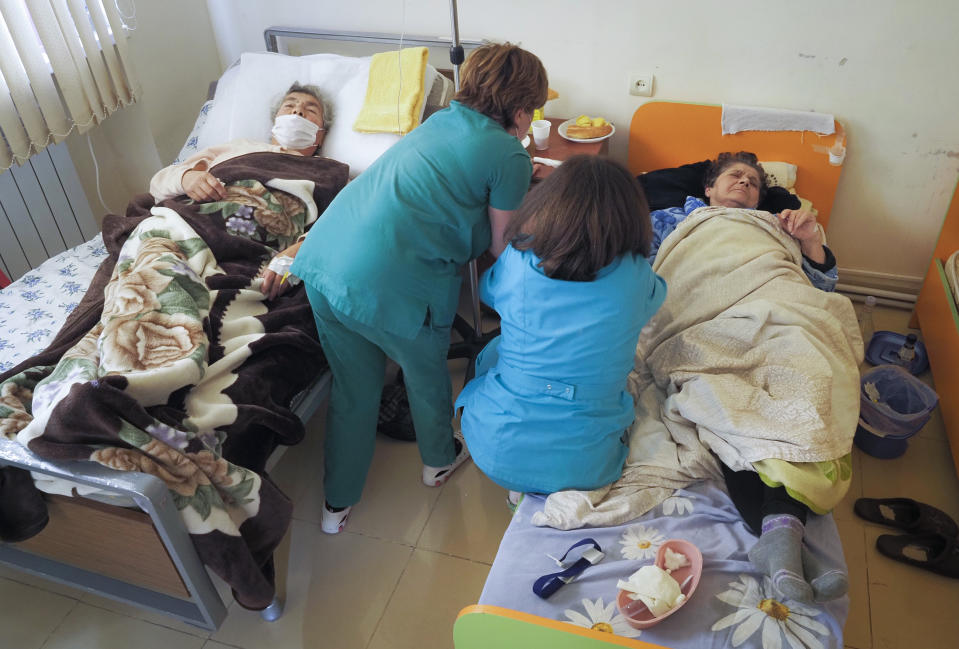 Nurses administer medicine to a patient wounded from shelling by Azerbaijan's artillery in a hospital, during a military conflict in Stepanakert, the separatist region of Nagorno-Karabakh, Saturday, Oct. 17, 2020. The latest outburst of fighting between Azerbaijani and Armenian forces began Sept. 27 and marked the biggest escalation of the decades-old conflict over Nagorno-Karabakh. The region lies in Azerbaijan but has been under control of ethnic Armenian forces backed by Armenia since the end of a separatist war in 1994. (AP Photo)