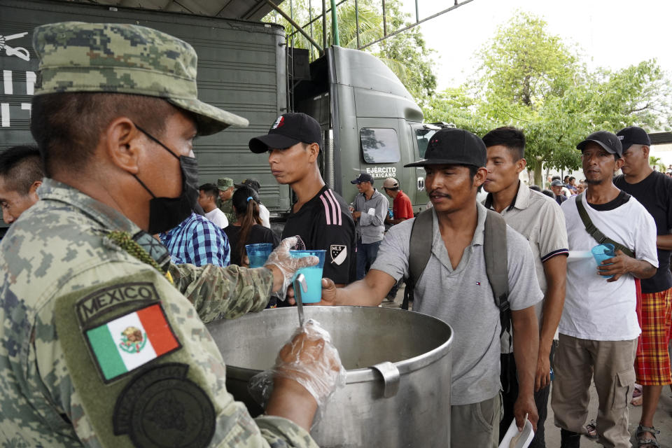 Residents receive food rations provided by Mexican army soldiers, members of the DN-III (Natural Disasters) plan, following the passage of Hurricane Beryl at the City Council square in Tulum, Quintana Roo State, Mexico, on July 5, 2024. Hurricane Beryl slammed into Mexico's Yucatan Peninsula Friday near the resort town of Tulum with fierce winds, US forecasters said. The National Hurricane Center said the storm was packing maximum sustained winds of 100 mph (160 kph) making it a Category 2 hurricane, weaker than earlier in the week as Beryl hit islands in the Caribbean. (Photo by Elizabeth RUIZ / AFP) (Photo by ELIZABETH RUIZ/AFP via Getty Images)