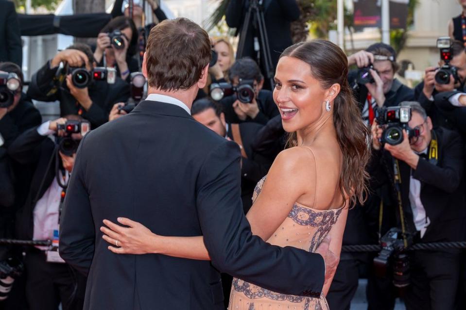 Alicia Vikander turns around as she poses with husband Michael Fassbender