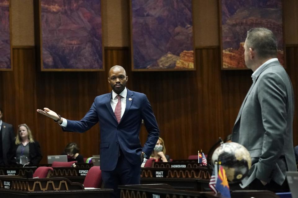 House Minority Leader Reginald Bolding, D-Laveen, left, talks with Arizona House Majority Leader Ben Toma, R-Peoria, during a vote on the Arizona budget Thursday, June 24, 2021, in Phoenix. (AP Photo/Ross D. Franklin)