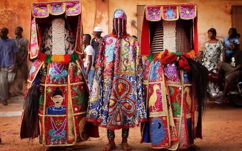 Nigerian Yaruba Voodoo Spirits at the Ouidah Voodoo Festival - Credit: Getty