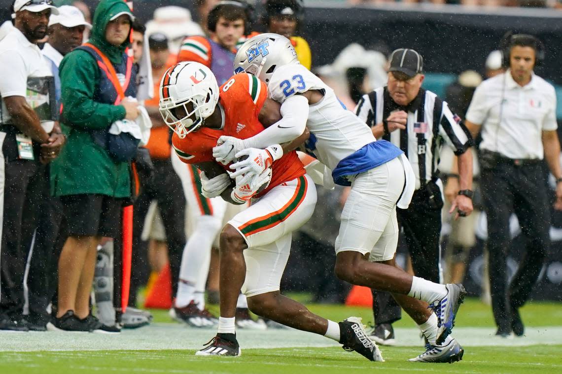 Middle Tennessee cornerback Jalen Jackson (23) takes Miami wide receiver Frank Ladson Jr. (8) out of bounds during the first half of an NCAA college football game, Saturday, Sept. 24, 2022, in Miami Gardens, Fla. (AP Photo/Wilfredo Lee)
