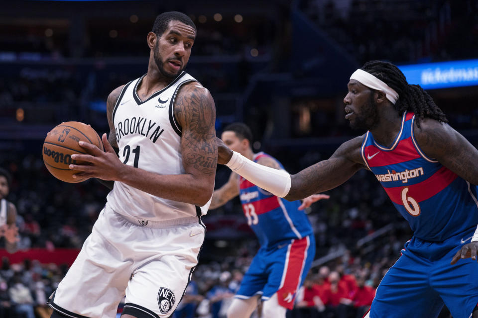 Brooklyn Nets center LaMarcus Aldridge, left, is defended by Washington Wizards center Montrezl Harrell during the first half of an NBA basketball game Wednesday, Jan. 19, 2022, in Washington. (AP Photo/Evan Vucci)