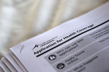 The federal government forms for applying for health coverage are seen at a rally held by supporters of the Affordable Care Act, widely referred to as "Obamacare", outside the Jackson-Hinds Comprehensive Health Center in Jackson, Mississippi, U.S. on October 4, 2013. REUTERS/Jonathan Bachman/File Photo