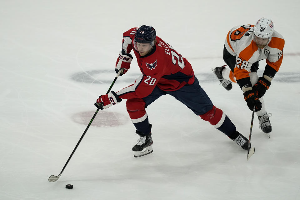 Washington Capitals center Lars Eller (20) tries to get away from Philadelphia Flyers center Claude Giroux (28) during the first period of an NHL hockey game, Friday, May 7, 2021, in Washington. (AP Photo/Alex Brandon)