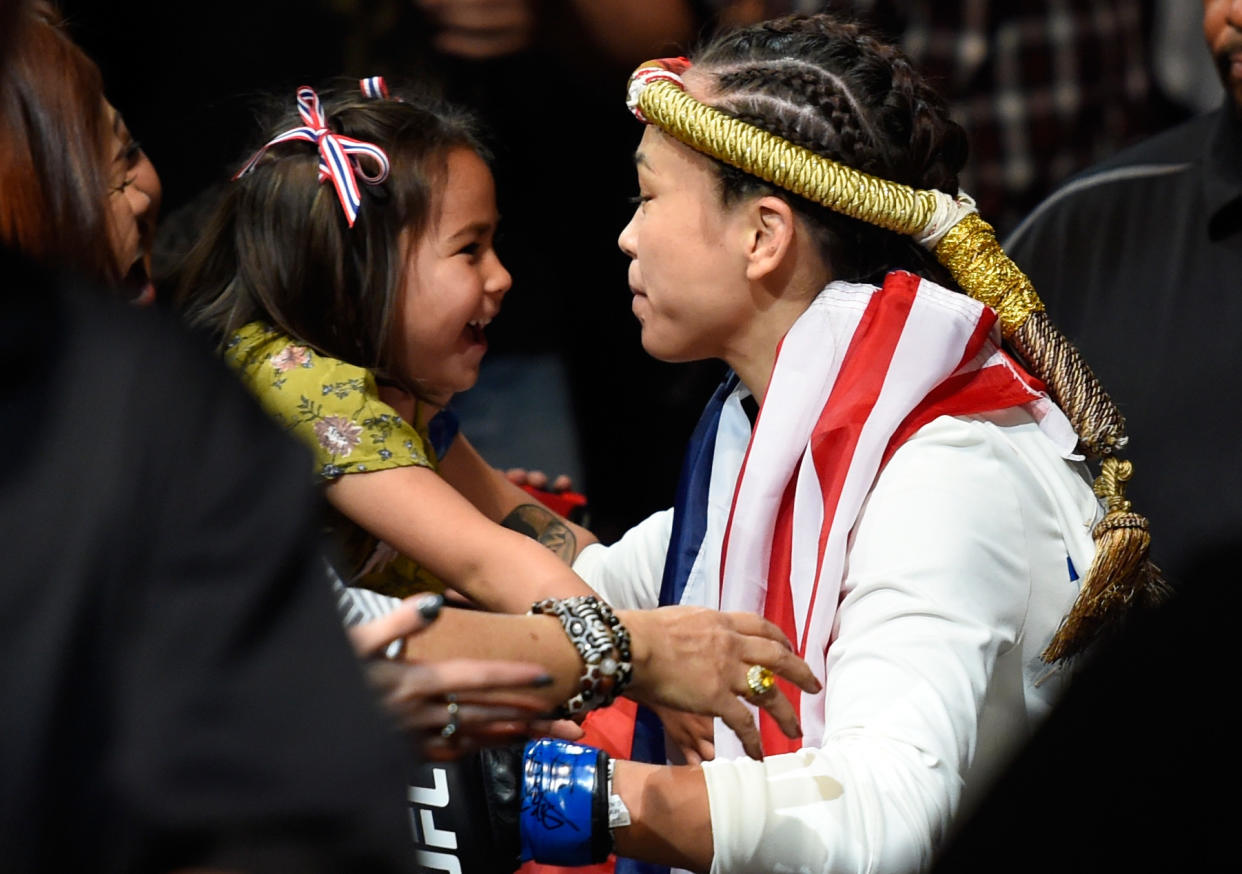 KANSAS CITY, MO - APRIL 15:  Michelle Waterson kisses her daughter Araya Waterson before entering the Octagon during the UFC Fight Night event at Sprint Center on April 15, 2017 in Kansas City, Missouri. (Photo by Josh Hedges/Zuffa LLC/Zuffa LLC via Getty Images)