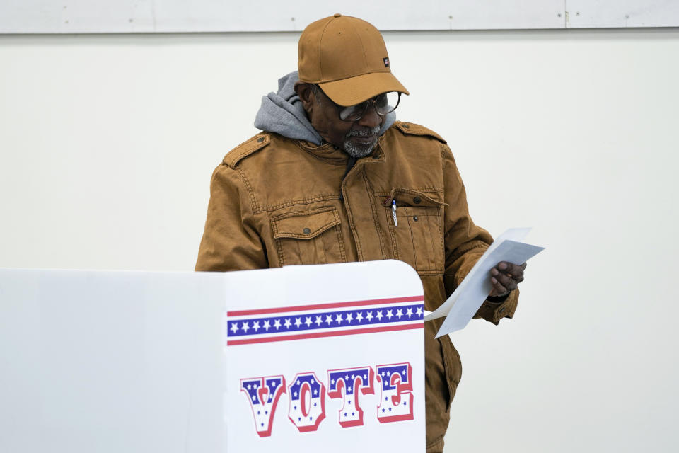 A voter casts an early ballot at a polling station in Milwaukee