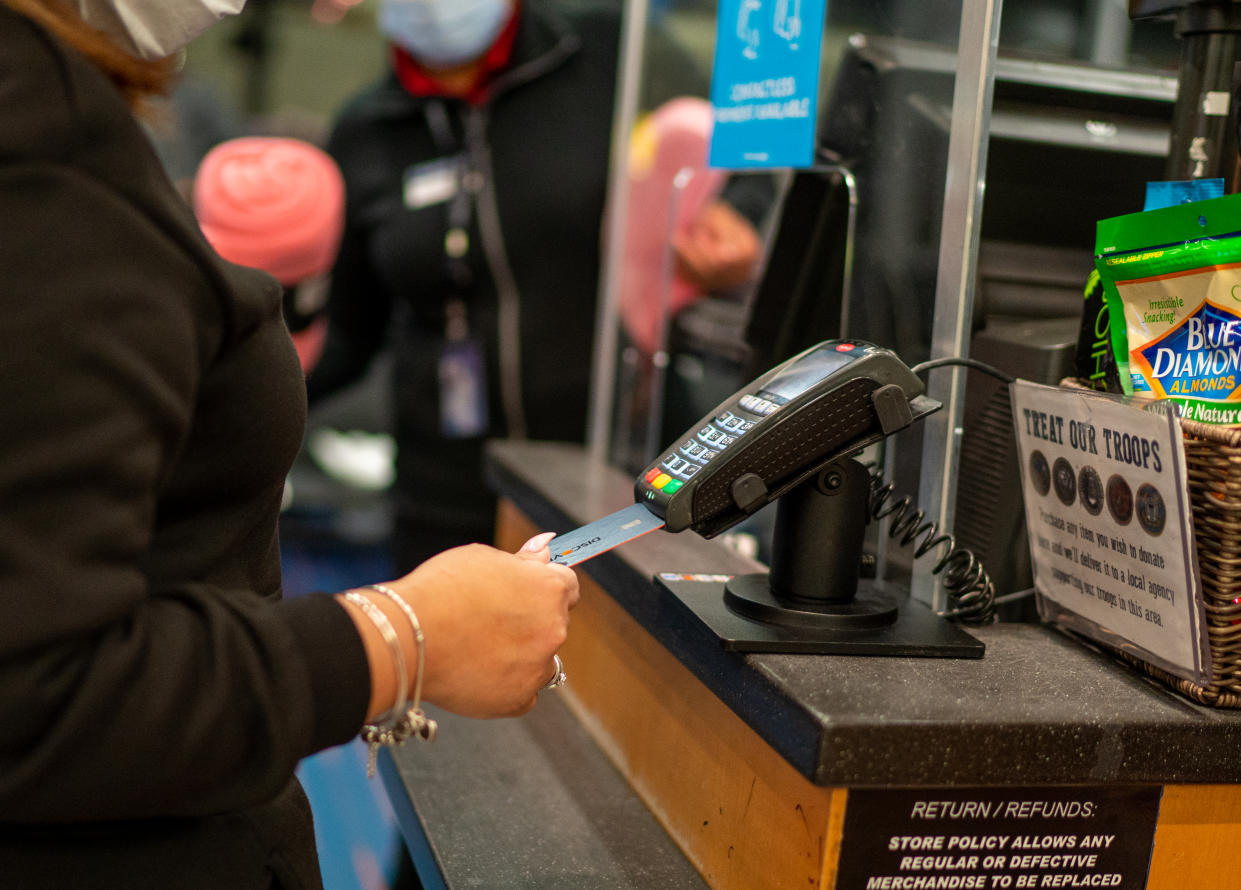 An air traveler uses a credit card to pay for items January 28, 2022 at a retail shop in John F. Kennedy International Airport in New York City. (Credit: Robert Nickelsberg, Getty Images)