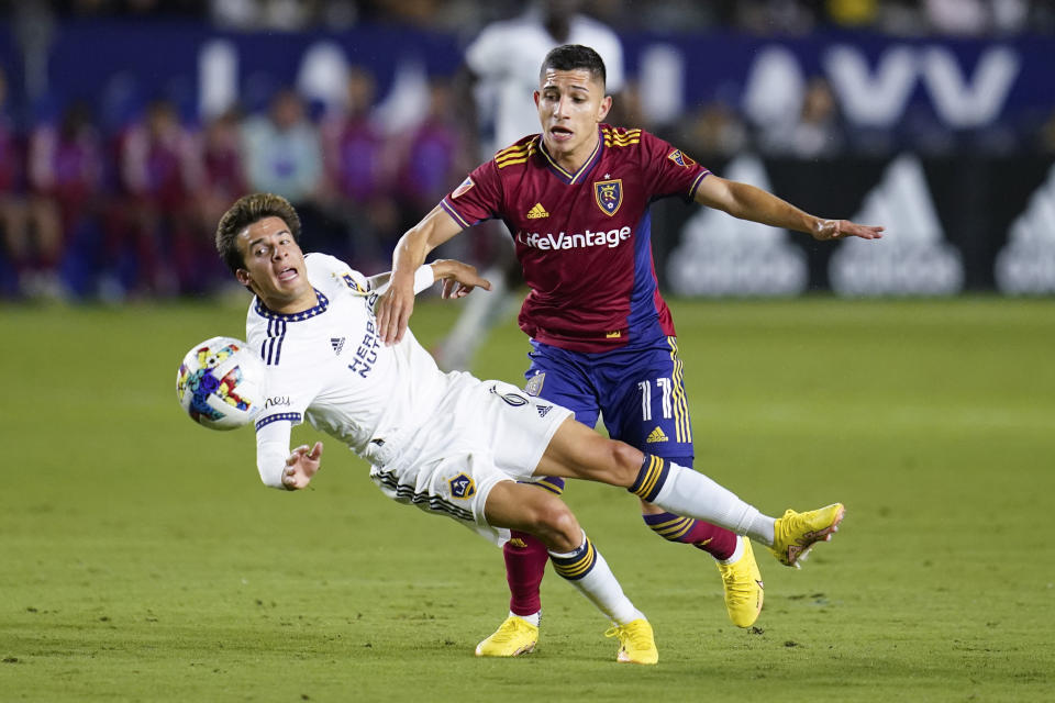 LA Galaxy midfielder Riqui Puig (6) is tripped up by Real Salt Lake forward Jefferson Savarino (11) during the first half of an MLS soccer match in Carson, Calif., Saturday, Oct. 1, 2022. (AP Photo/Ashley Landis)