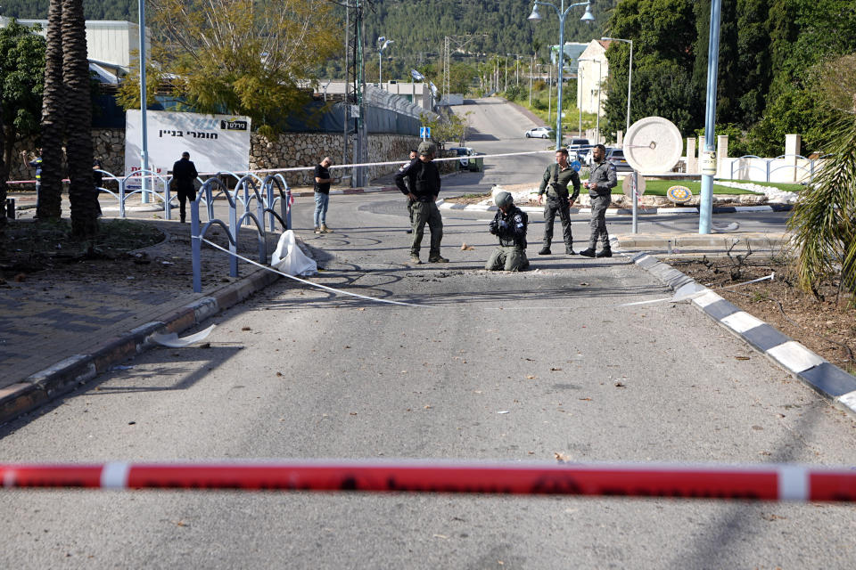 Israeli police remove remains of an intercepted rocket fired from Lebanon that landed in Shlomi, northern Israel Thursday, April 6, 2023. Israeli air defenses intercepted a rocket fired from Lebanon into northern Israel, the Israeli military said. It was not immediately clear who was behind the rare rocket fire from Lebanon. (AP Photo/Ariel Schalit)