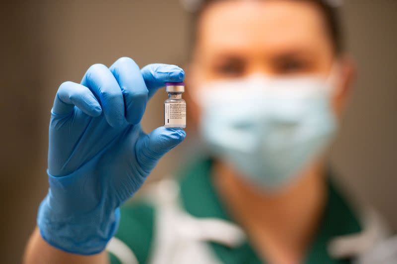 A nurse holds a phial of the Pfizer/BioNTech COVID-19 vaccine at University Hospital in Coventry