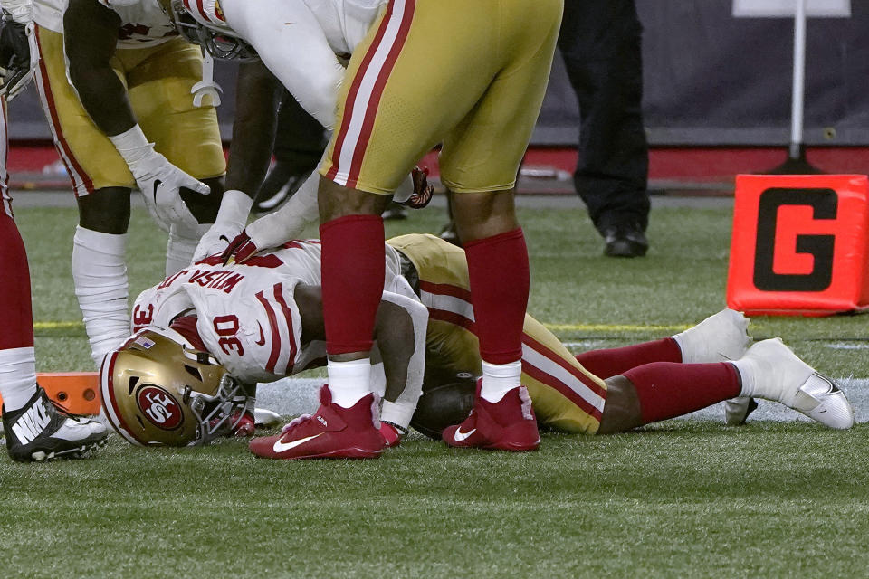 San Francisco 49ers running back Jeff Wilson Jr. lies on the turf after an injury while scoring a touchdown in the second half of an NFL football game against the New England Patriots Sunday, Oct. 25, 2020, in Foxborough, Mass. (AP Photo/Steven Senne)