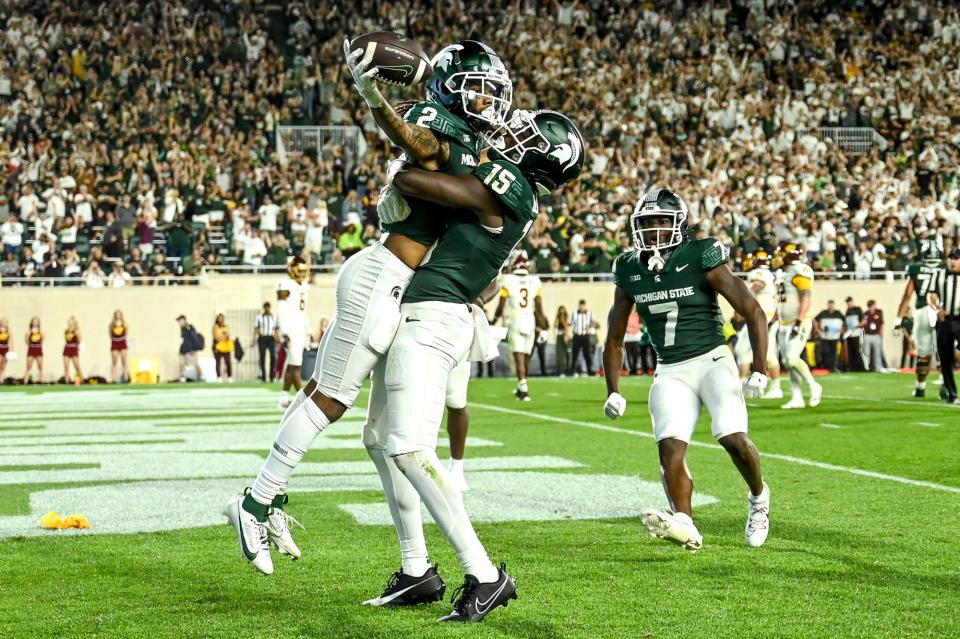 Michigan State's Tyrell Henry, left, celebrates his touchdown against Central Michigan Jaron Glover during the fourth quarter on Friday, Sept. 1, 2023, at Spartan Stadium in East Lansing.