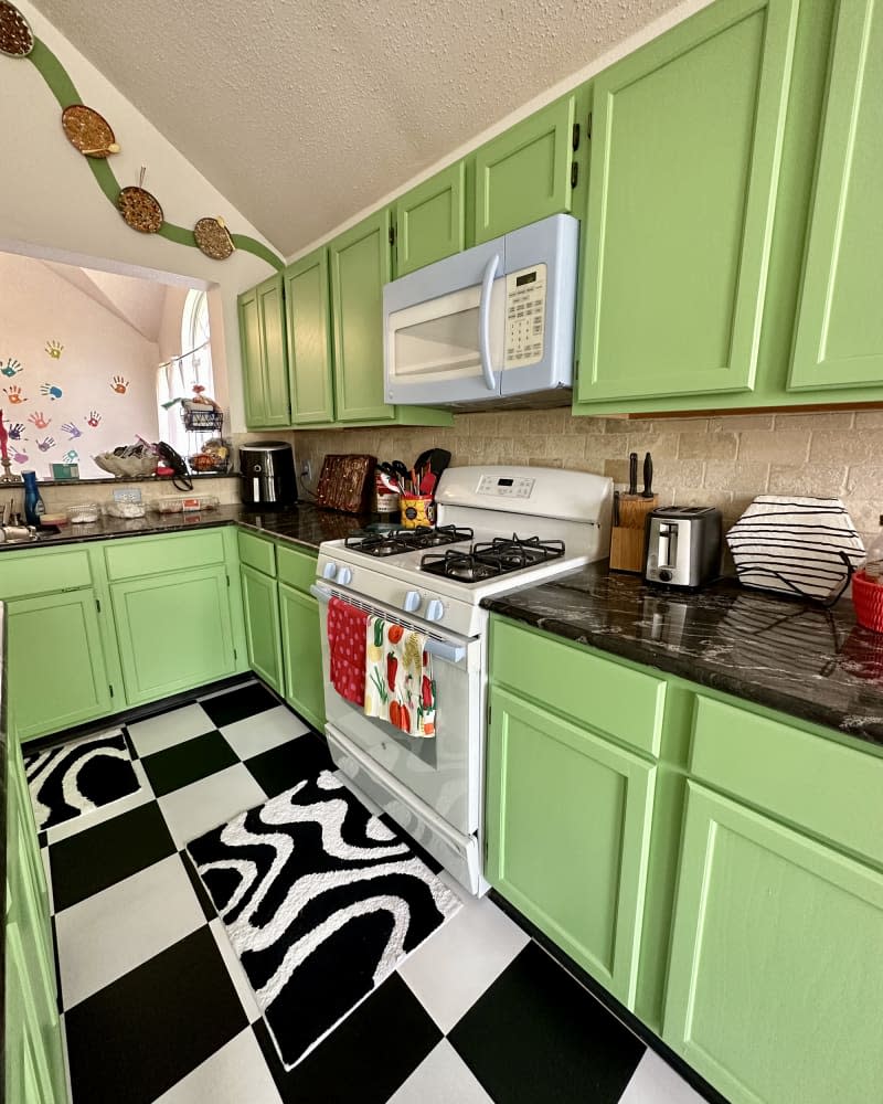 Kitchen with black and white floor and bright green cabinets