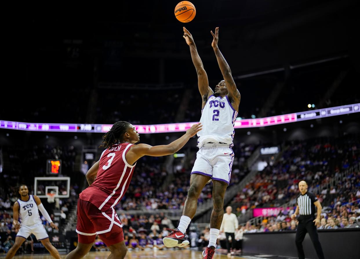 KANSAS CITY, MISSOURI - MARCH 13: Emanuel Miller #2 of the TCU Horned Frogs shoots against Otega Oweh #3 of the Oklahoma Sooners during the first half of the game in the second round of the Big 12 Men's Basketball Tournament at T-Mobile Center on March 13, 2024 in Kansas City, Missouri. (Photo by Jay Biggerstaff/Getty Images)