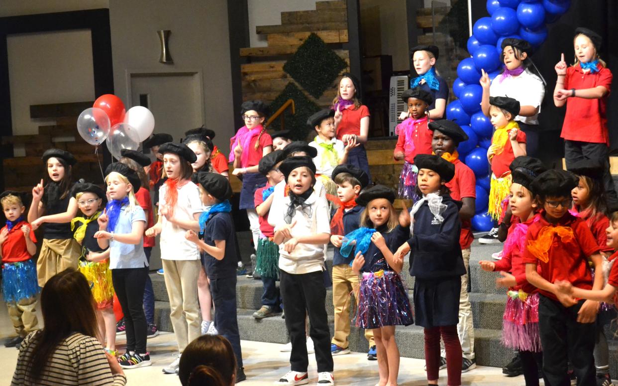 Students in the French dual-language immersion program at Axis International Academy in Fort Collins sing during a ceremony at the school Monday to celebrate the school earning the Label of FrancEducation from the French Ministry of Education and Youth.
