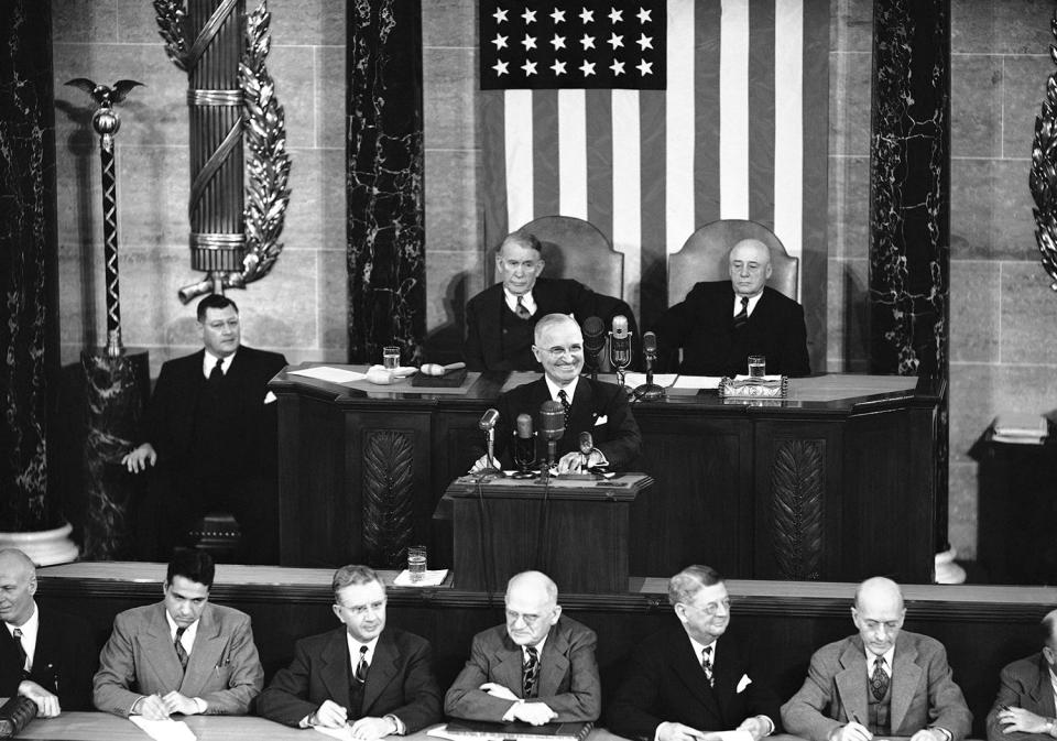 President Harry Truman was unusually grim as he addressed Congress in Washington on Jan. 8, 1951, but he did grin as Republicans responded with yells when he called for “rigid economy” in non-defense spending.
