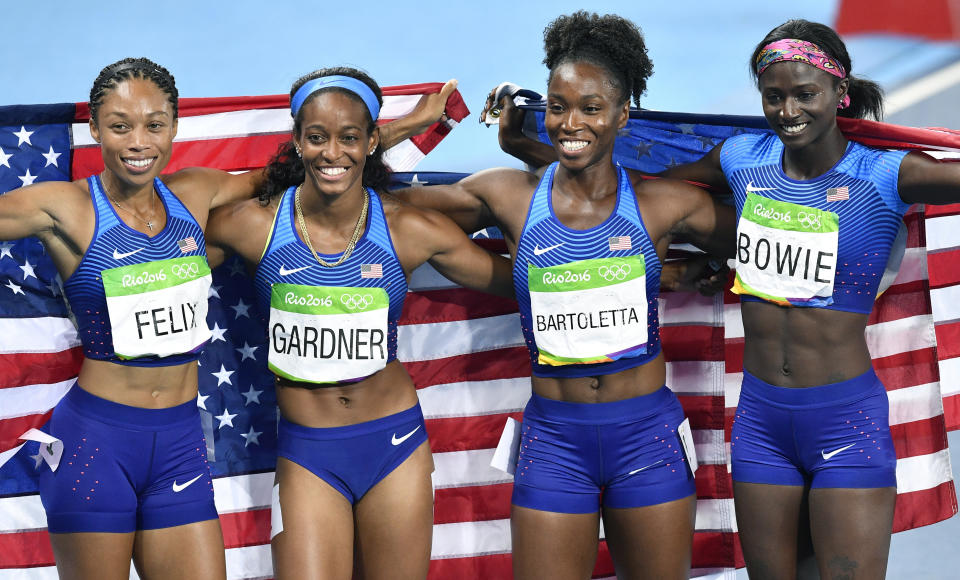 The United States team from left, Allyson Felix, English Gardner, Tianna Bartoletta and Tori Bowie celebrate winning the gold medal in the women's 4x100-meter relay final during the athletics competitions of the 2016 Summer Olympics at the Olympic stadium in Rio de Janeiro, Brazil, Friday, Aug. 19, 2016. (AP Photo/Martin Meissner)