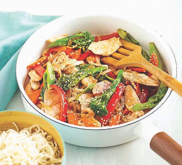 Skillet meal with chicken, broccoli, red peppers and sesame seeds