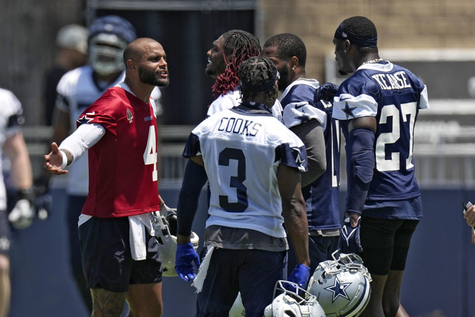 Dallas Cowboys quarterback Dak Prescott, left, has a conversation with safety Jayron Kearse, right, as wide receiver CeeDee Lamb, second from left, and wide receiver Brandin Cooks stand by during the NFL football team's training camp Saturday, July 29, 2023, in Oxnard, Calif. (AP Photo/Mark J. Terrill)