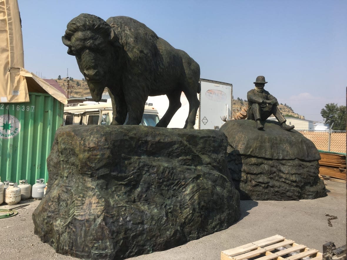 The Buffalo and the Buffalo Fur Trader was completed by artist Ken Lum in 2016. It features two bronze statues measuring 4 metres and 3.5 metres in height. (Ken Lum - image credit)