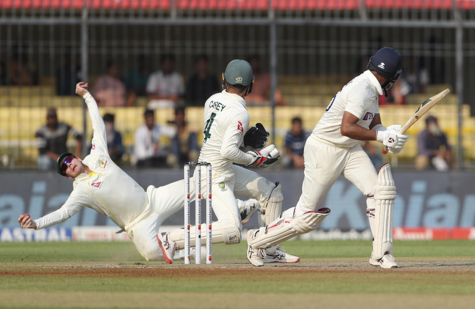 Australia's captain Steve Smith, left, drives to takes a catch to dismiss India's Cheteshwar Pujara, right, during the second day of third cricket test match between India and Australia in Indore, India, Thursday, March 2, 2023. (AP Photo/Surjeet Yadav)