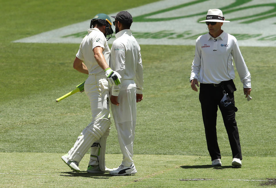 Umpire Chris Gaffaney watches on as the pair collide. Pic: Getty