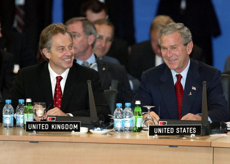 FILE - U.S. President George W. Bush, right, and British Prime Minister Tony Blair laugh together during the meeting of the Euro-Atlantic Partnership Council at the NATO summit in Istanbul, Turkey, June 29, 2004. (AP Photo/Charles Dharapak, File)