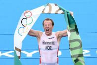 <p>Norway's Kristian Blummenfelt celebrates his gold medal finish in the men's individual triathlon competition on July 26.</p>