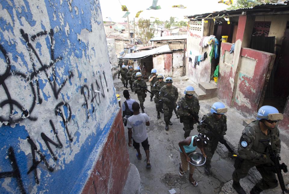 In this Feb. 22, 2017 photo, U.N. peacekeepers from Brazil patrol the Cite Soleil slum in Port-au-Prince, Haiti. They faced no greater threat than a few barking dogs along some of the same streets where pitched gun battles between gangs and U.N. peacekeepers used to be a daily occurrence. (AP Photo/Dieu Nalio Chery)