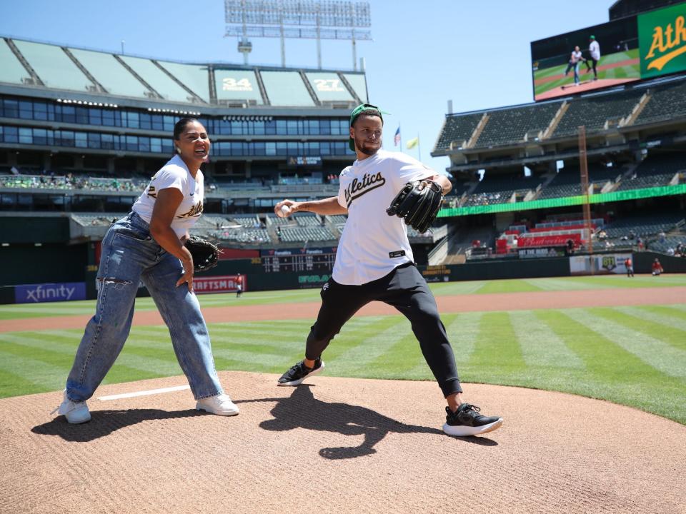 Ayesha and Stephen Curry throw out a pitch at an Oakland A's game.