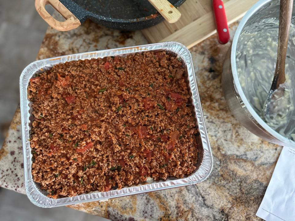 meat lasagna arranged in a metal hotel pan