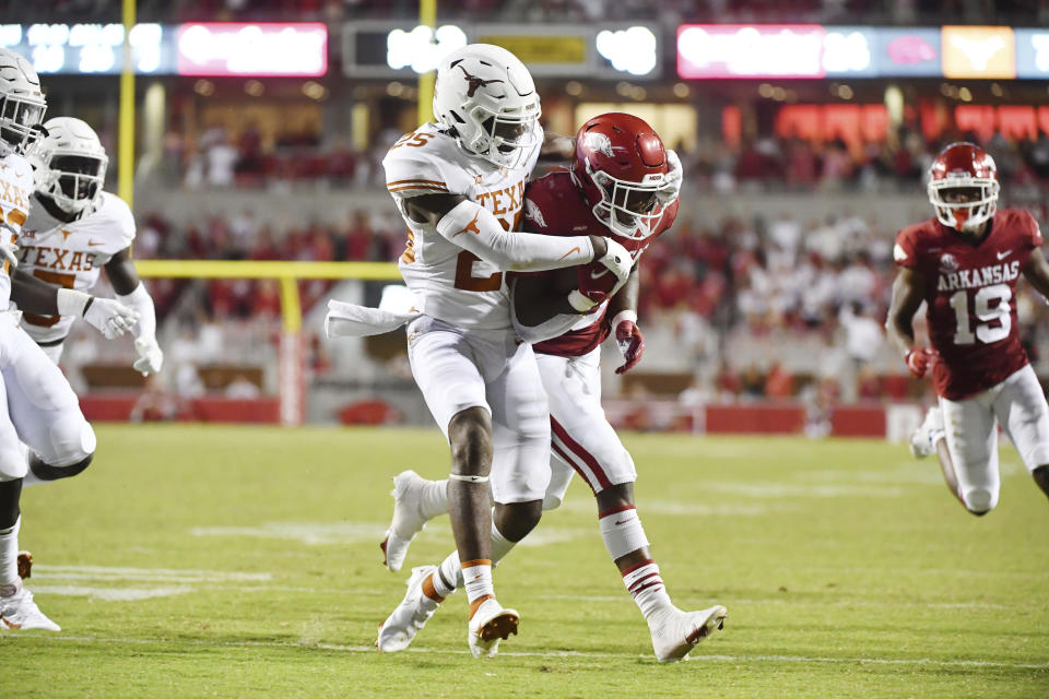 Arkansas running back Raheim Sanders (5) powers past Texas defender B.J. Foster (25) to score a touchdown during the second half of an NCAA college football game Saturday, Sept. 11, 2021, in Fayetteville, Ark. (AP Photo/Michael Woods)