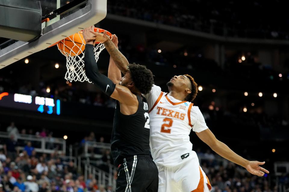 Xavier forward Jerome Hunter (2) finishes a dunk as Texas guard Arterio Morris (2) defends during the first half of a Sweet 16 game in the NCAA tournament earlier this year on March 24 at the T-Mobile Center in Kansas City. Morris later transferred to Kansas.