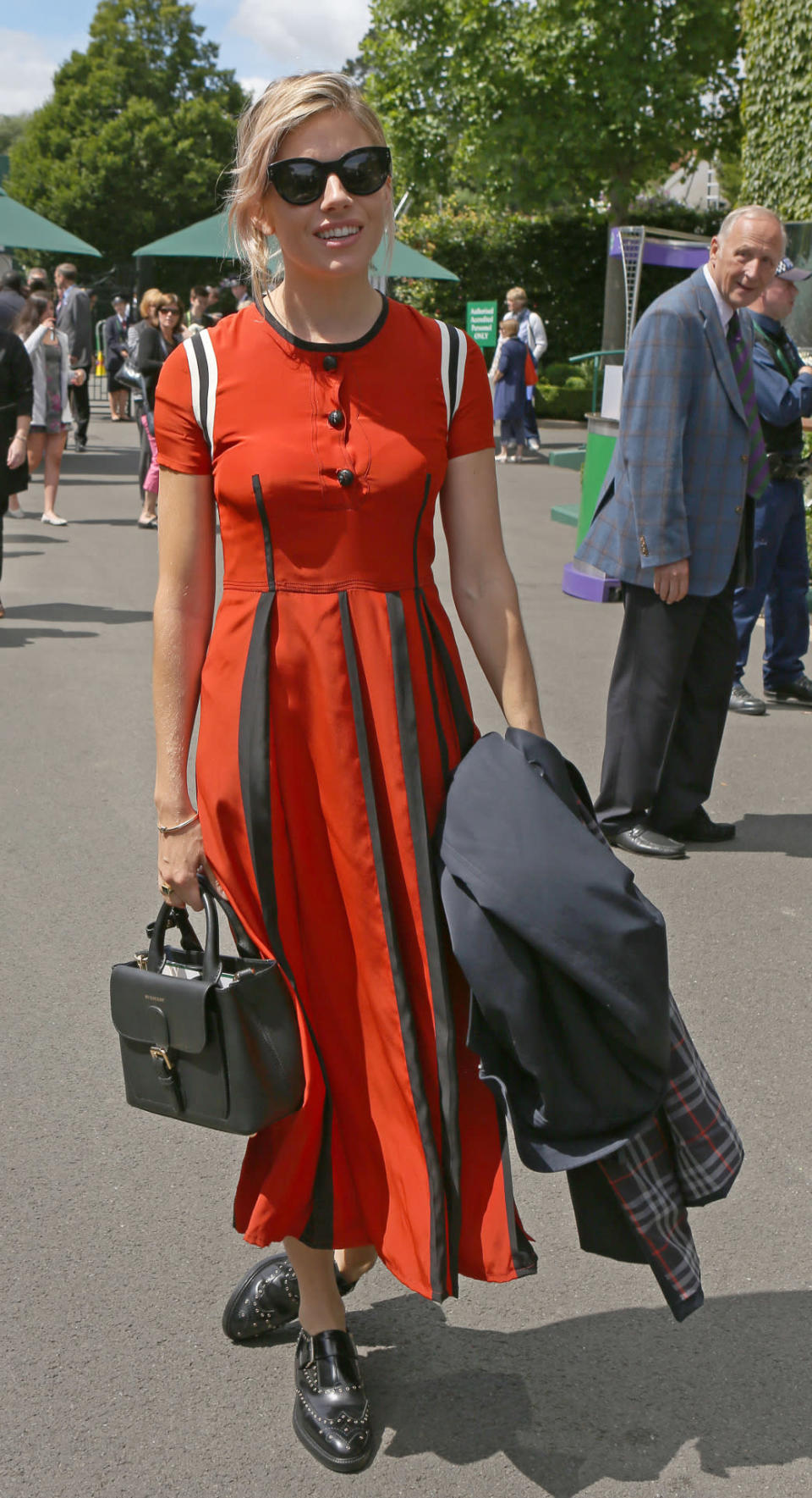 <p>The actress caught the eye of fellow spectators in a red, black and white midi dress and androgynous brogues.<i> [Photo: PA Images]</i></p>