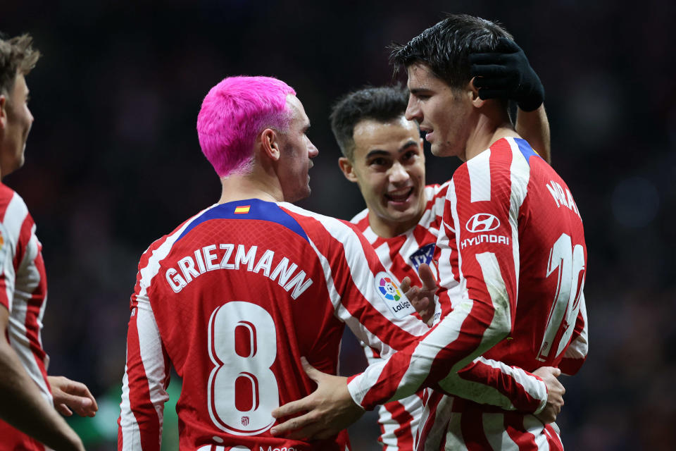 Atletico Madrid's Spanish forward Alvaro Morata (R) celebrates scoring his team's second goal with Atletico Madrid's French forward Antoine Griezmann during the Spanish League football match between Club Atletico de Madrid and Elche CF at the Wanda Metropolitano stadium in Madrid on December 29, 2022. (Photo by Pierre-Philippe Marcou / AFP)
