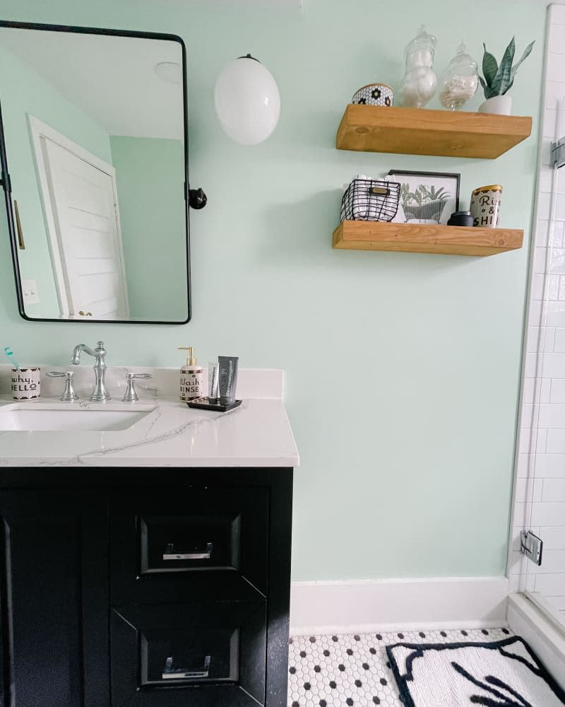 Wooden shelved in newly renovated bathroom.