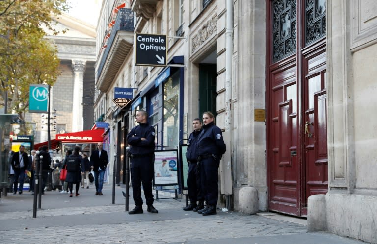 Police officers stand guard on October 3, 2016, in front of the Paris hotel residence where US reality television star Kim Kardashian was robbed of millions of dollars worth of jewelry