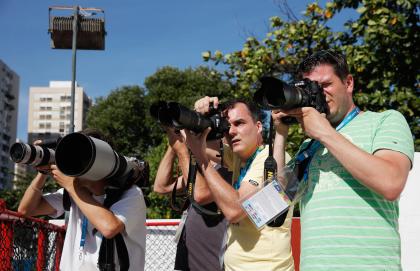 Dutch photographers take photos of the Netherlands' team practice. (Getty)