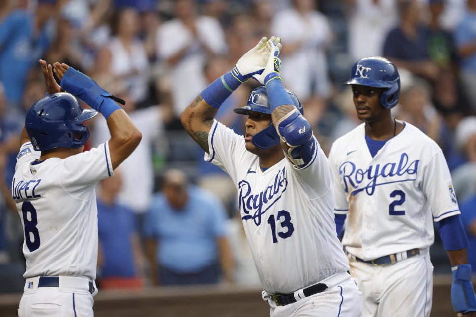 Kansas City Royals' Salvador Perez (13) is congratulated by teammates Nicky Lopez (8) and Michael A. Taylor (2) after hitting a three-run home run during the fifth inning of a baseball game against the Detroit Tigers at Kauffman Stadium in Kansas City, Mo., Saturday, July 24, 2021. (AP Photo/Colin E. Braley)