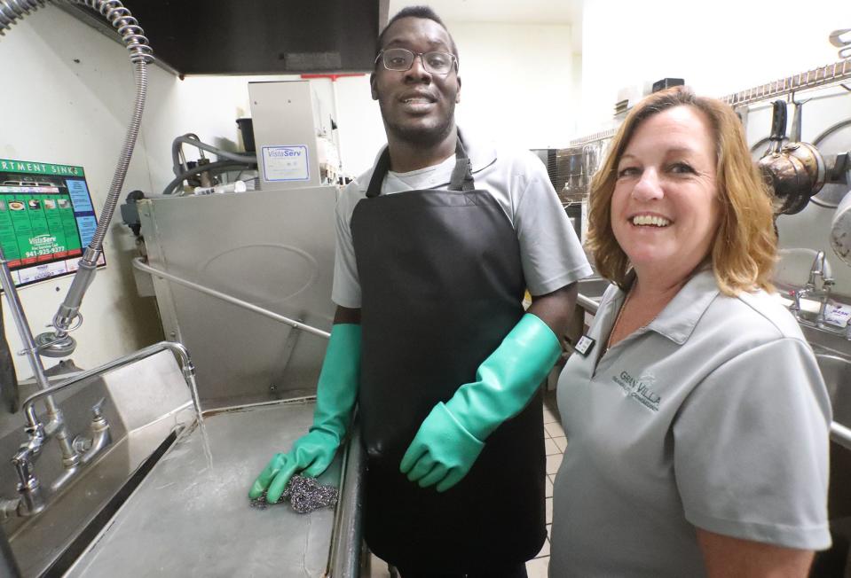 Project SEARCH student Elijah Holloway and instructor Jill Kulwicki, Thursday, Dec. 15, 2022, at Grand Villa in Palm Coast where Holloway interns washing dishes. Project SEARCH is a national program for students with disabilities who complete one-year internships to gain work experience and employability skills.