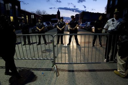 Members of the Baltimore Police Department stand behind barriers outside of the Western District police station during a rally for Freddie Gray, in Baltimore April 21, 2015. REUTERS/Jose Luis Magana