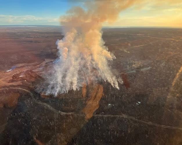 An April 22 aerial image of a wildfire burning southeast of Fort McMurray near the hamlet of Saprae Creek Estates. The fire is among 70 burning across Alberta Wednesday.  (Alberta Wildfire - image credit)