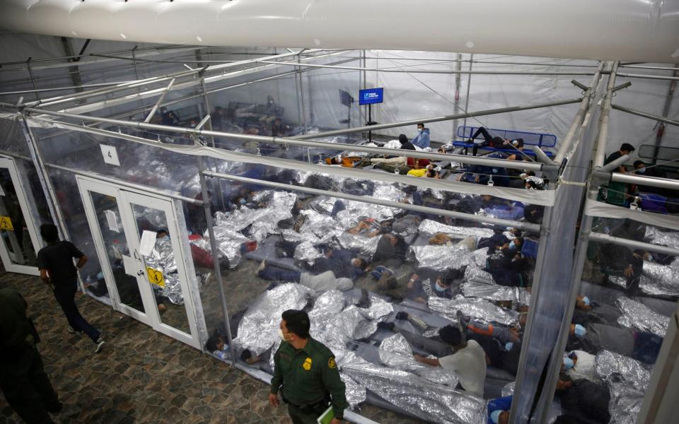 Minors lie inside a pod at the Donna Department of Homeland Security holding facility, the main detention center for unaccompanied children in the Rio Grande Valley - AP Photo/Dario Lopez-Mills