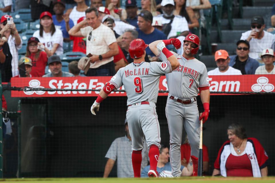 Matt McLain (9), who grew up 10 minutes from the Angels' stadium, celebrates with Spencer Steer after hitting a home run in his first big-league at-bat at his hometown ballpark.